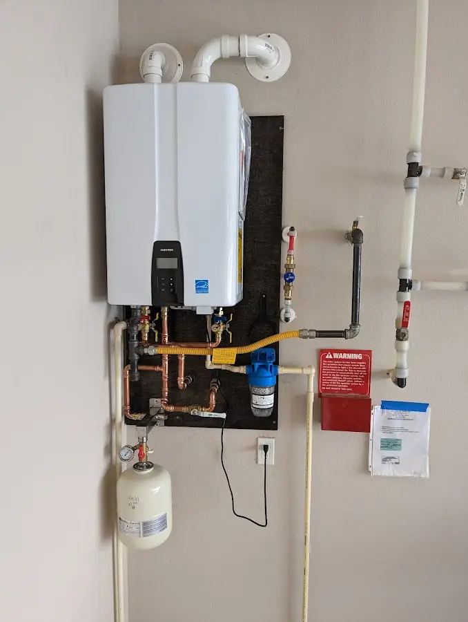 Professional plumber installing copper piping in a Graham home